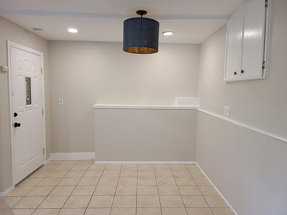 Dining area. Large overhead storage behind the cabinet doors.