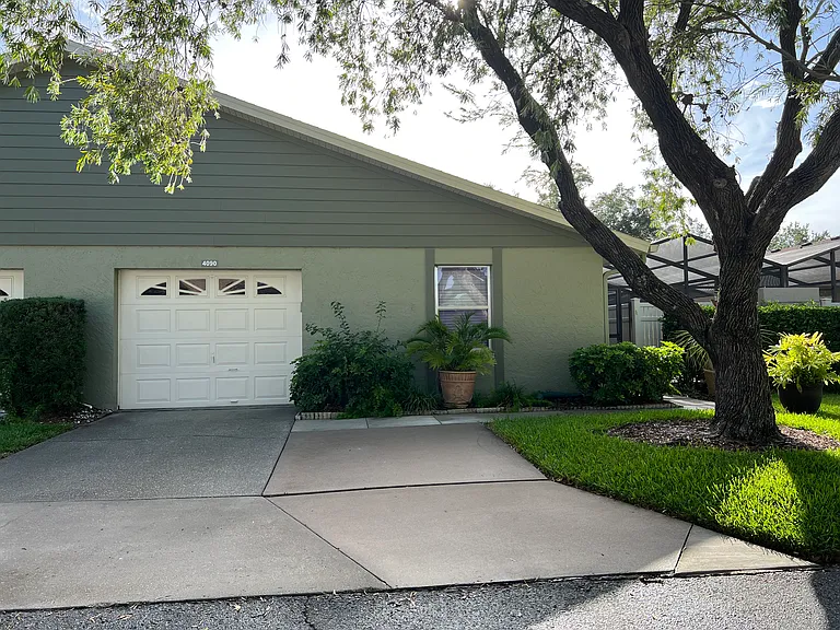 The front view with enclosed garage and two private outside parking spaces