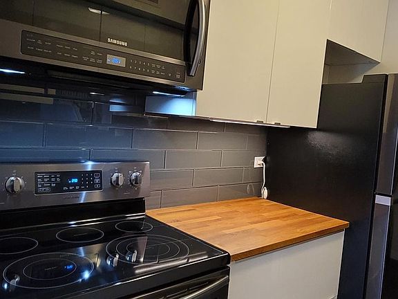 Under cabinet lighting and black stainless steel appliances