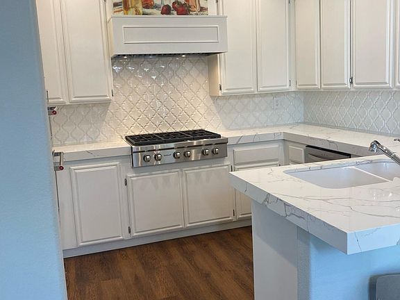 Lovely kitchen with hand poured backsplash, new quartz counters and plenty of upper as well as lower storage space. Wolf range, microwave and oven.