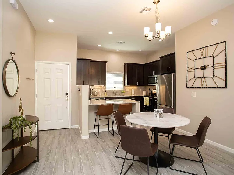 Open floor plan with dining area and high ceilings.
