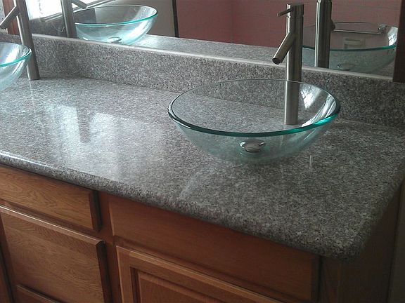 Luxury bathroom vanity with two vessel sinks, granite top.
