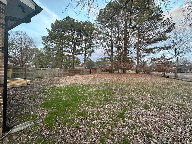 Large Fenced Rear Yard With Small Storage Building
