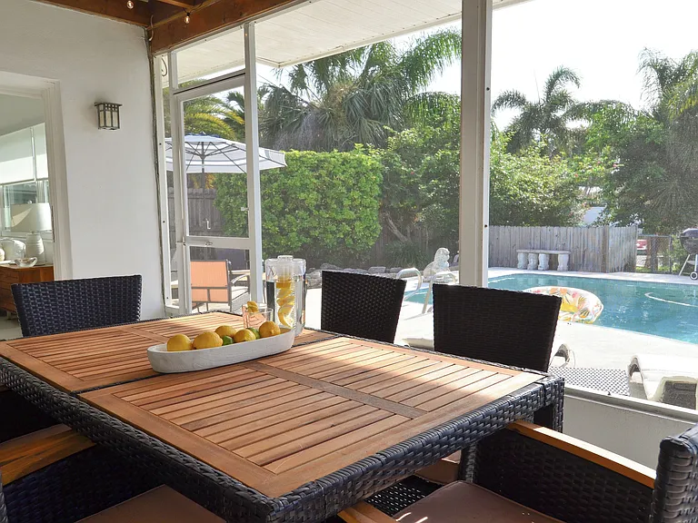Screened in patio with 6 seat dining set right off of the living room
