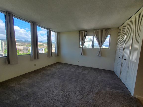 Primary bedroom features large floor to ceiling closet, black out curtains, and rare end unit windows to enjoy the tropical breezes