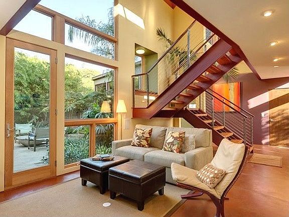 The light-filled, 2-story Family Room opens to the tropical, flagstone patio w