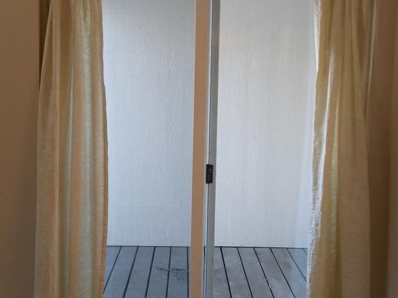 Sliding glass door that opens up to a deck overlooking the b