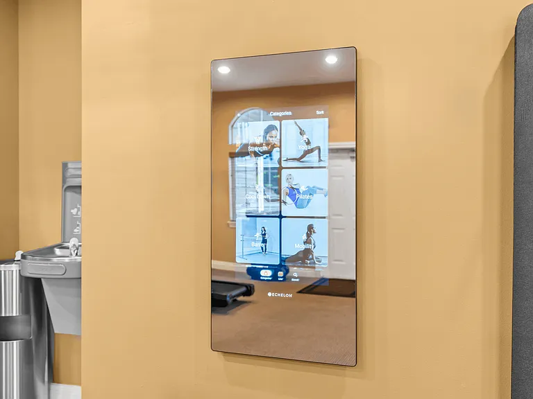Interactive fitness mirror offering guided workouts and wellness classes.