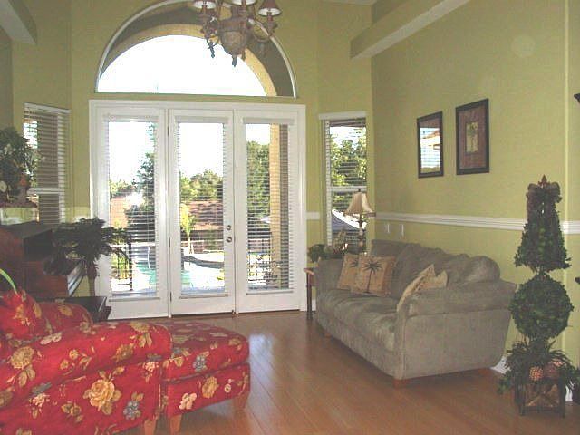 Step into a beautiful formal living room with pool views