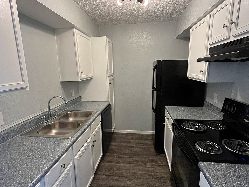 Newly renovated kitchen featuring black appliances and a spacious pantry cabinet.