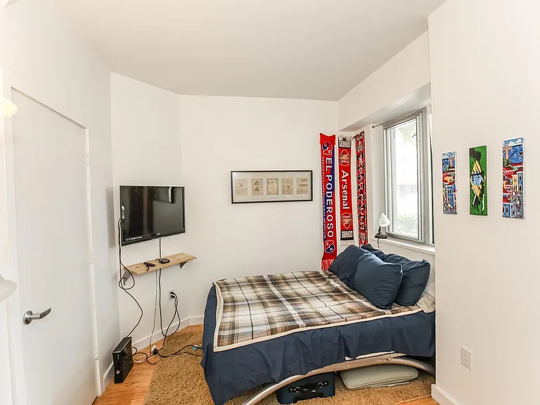 the smaller of the two bedrooms. Closet on left, storage shelves on the right.