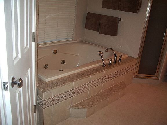 Master bathroom matching granite step, plus sprayer nozzle for tub cleaning