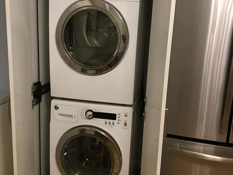 Built in washer and dryer hidden in built-in cabinet when not in use.