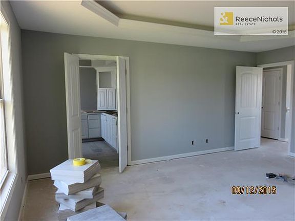 Owner's bedroom and bathroom under construction with white trim.