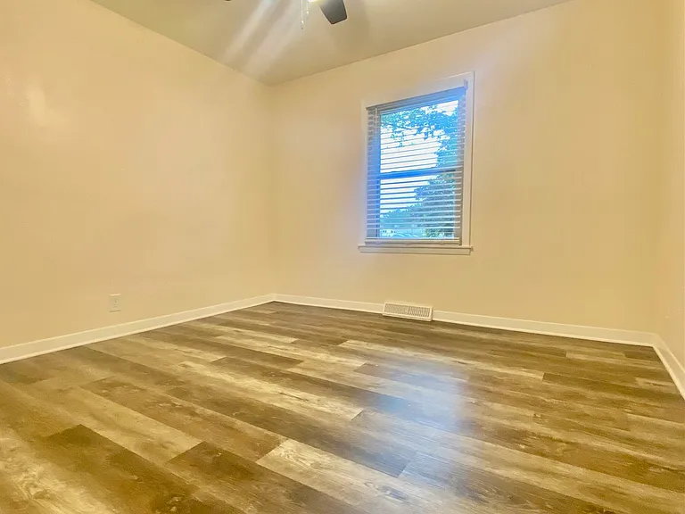 A different angle of the bedroom with window