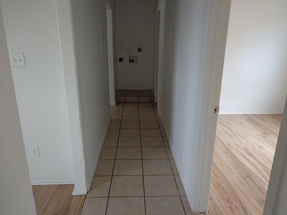 hallway leading to kitchen and bathroom from frontroom on left, bedroom right