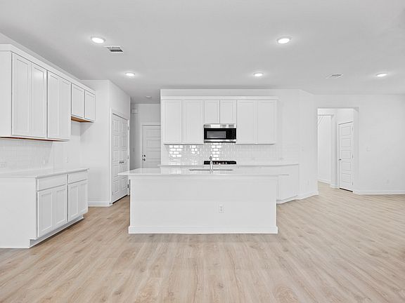 Kitchen in the Oak home plan by Trophy Signature Homes - REPRESENTATIVE PHOTO