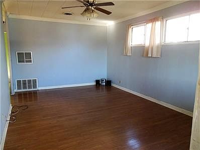 Living room is well lit and offers laminate wood flooring.