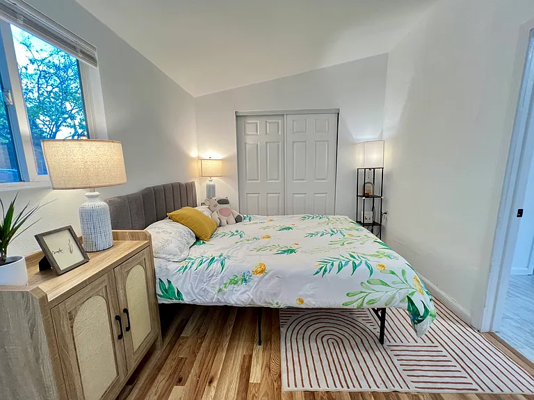 Bright private bedroom with new flooring, great natural light, and generous closet space