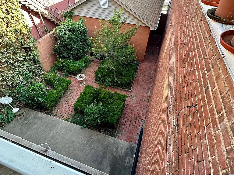 Garden and fountain courtyard with a private entrance to the right