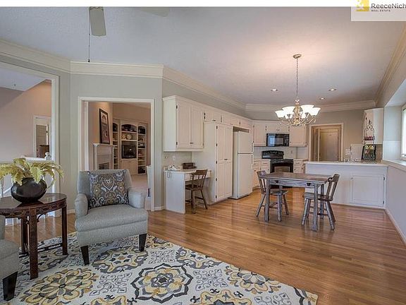 Open kitchen area with hardwood floors and tons of cabinets!