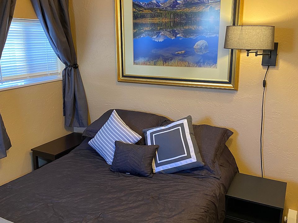 Full /double sized bed, with side table and reading lamp.