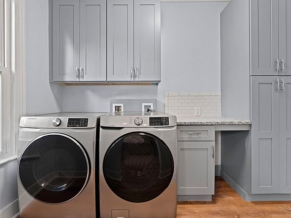 Private new HE washer and dryer in the pantry room right off the kitchen with additional all wood storage cabinets