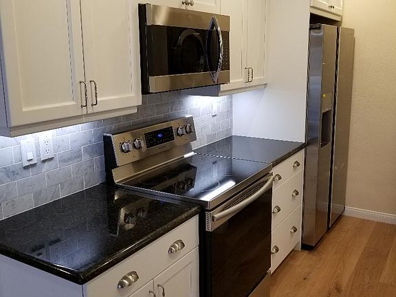 Ample countertop surfaces for food preparation in the kitchen area.
