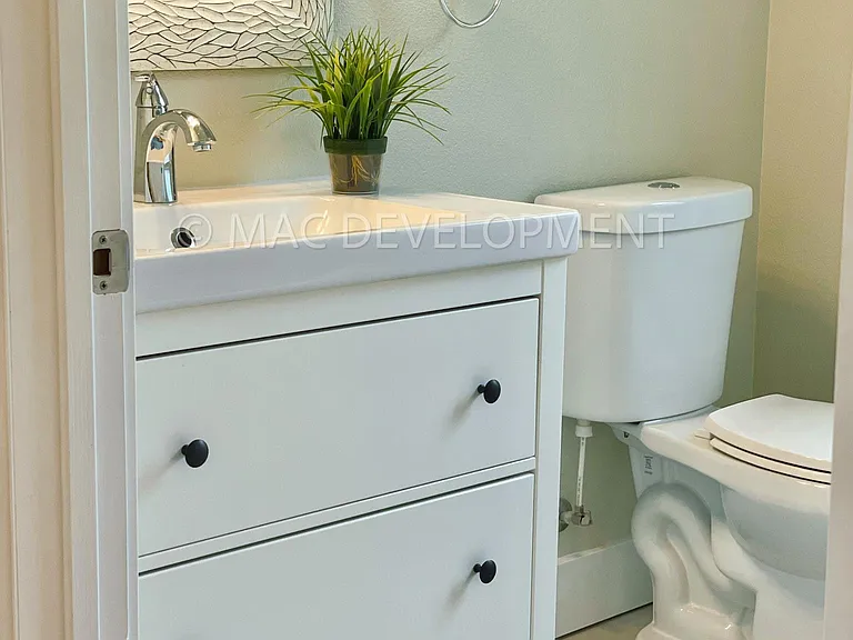 Tile floor in bathroom and storage in sink vanity.