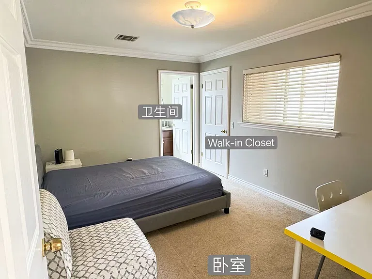 Bright and airy second bedroom featuring an attached full bath, plush carpeting, and a desirable walk-in closet.