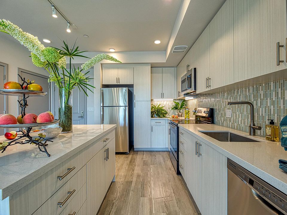 Light_filled kitchen with granite counters, energy_efficient appliances, and a clean, streamlined design.