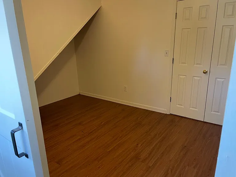 Looking through door into bedroom. Doors on right open to laundry room