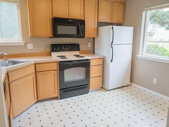 Plenty of natural light in the kitchen, large enough to accommodate dining table for casual eating.