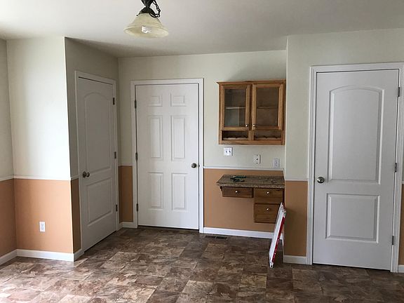 Kitchen area, closet, door to garage, dest and pantry doors (left to right)