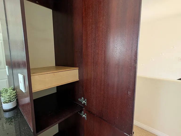Bathroom features ample storage between the under-sink cabinet and the extra tall cabinet next to the sink.
