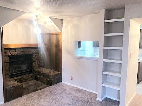 Living Room Looks Into Kitchen Pass Thru, Fireplace Feature & Dining Room