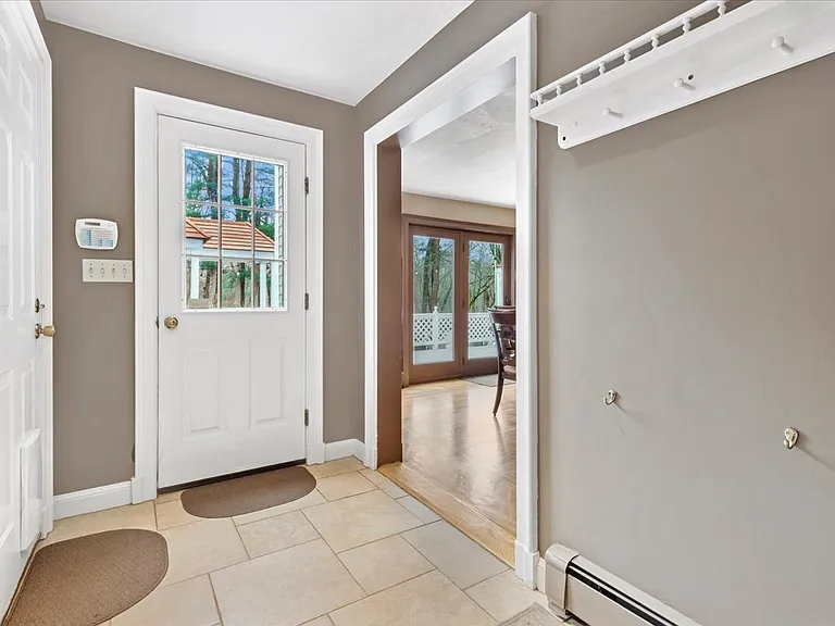 Mud room coming in from garage with 2 other doors to deck and great room