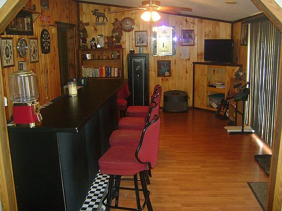 full size bar with mini fridge and stools