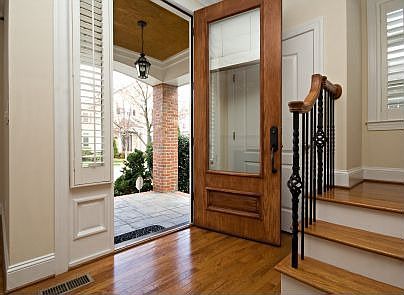 Stately front door with wrought iron railing on stairs