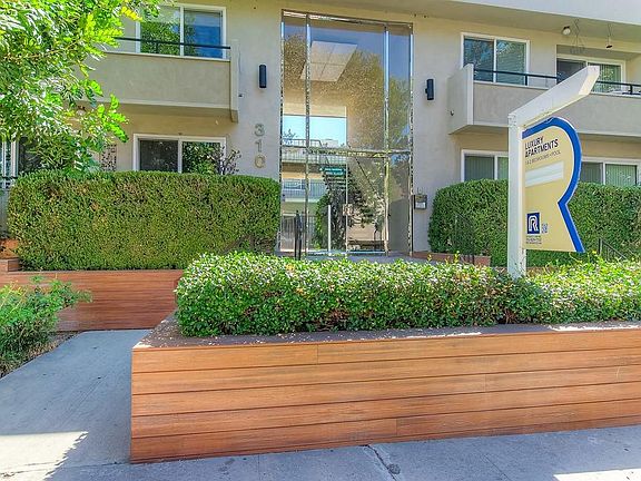 Secure entryway with beautiful landscaping.