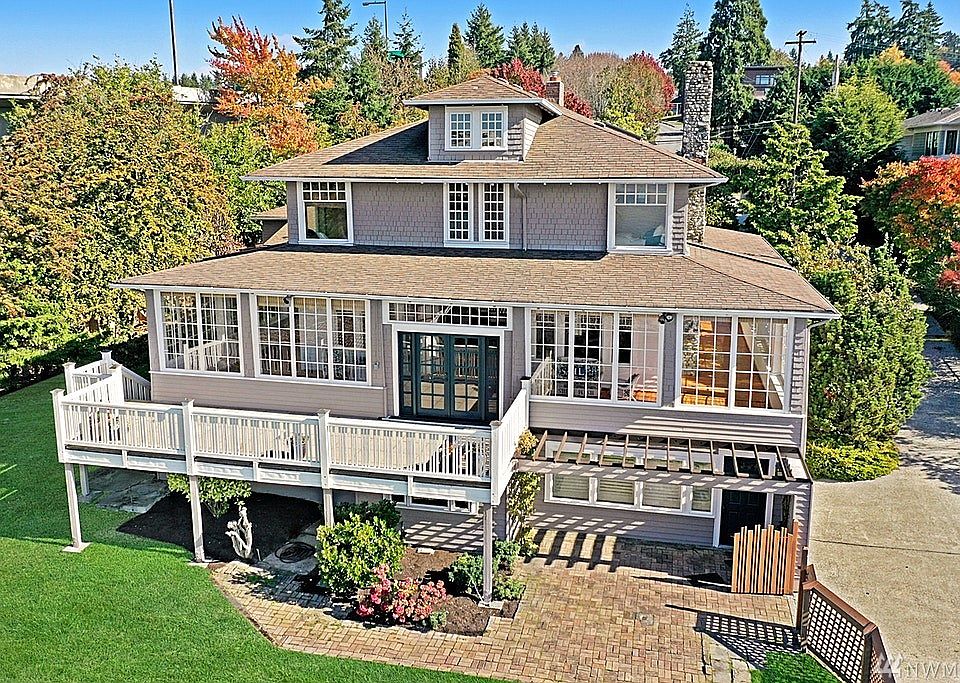 Sun drenched enclosed porch looking to unobstructed Lake Washington view.