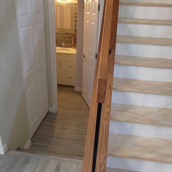 front entry with view towards half bath and stair case leading to bedrooms and full bath