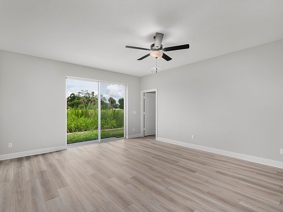 The family room has sliding glass doors that open into the backyard