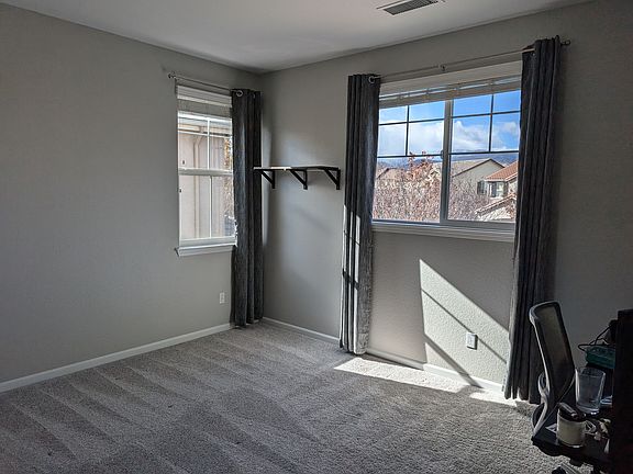 East side facing window with shelf, and curtains.