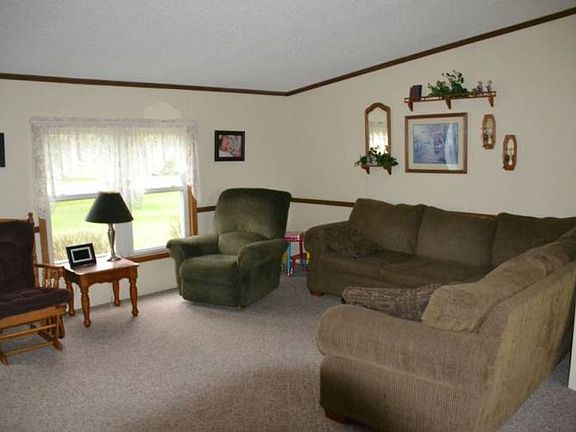 Great large open space for this living room.  It is the center of the home with easy access to all the rooms in the home.  It features a vaulted ceiling and a large picture window.