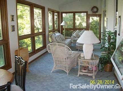 Three season room
						:
						Patio doors off kitchen on one end and master suite on other.