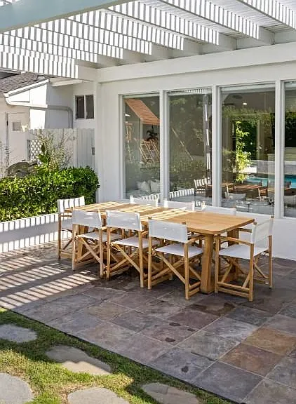 Wooden table on the patio, seating 8_an alfresco haven for delightful outdoor gatherings.