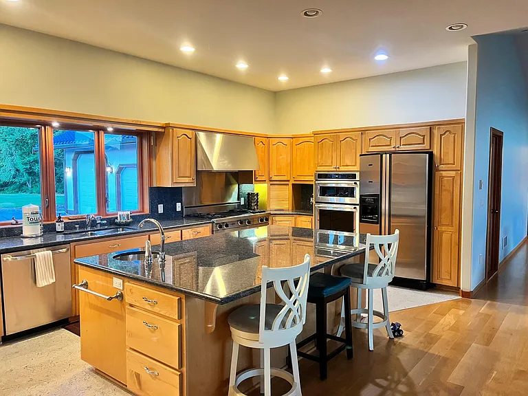 Kitchen with Viking stovetop and granite countertops
