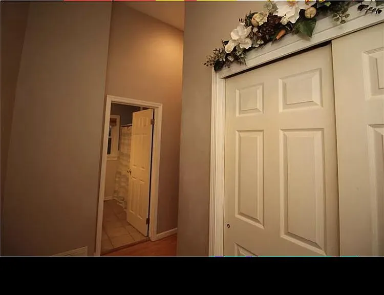 Hallway connecting front door, bedroom, bathroom and kitchen