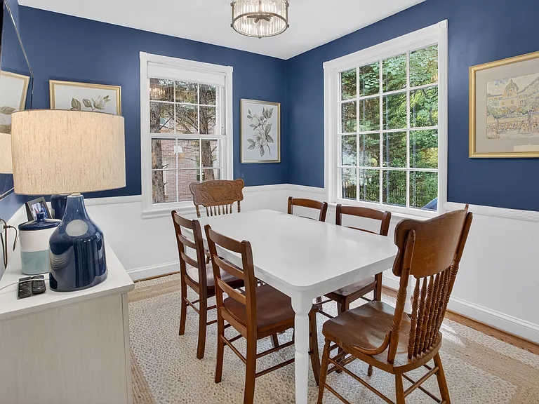 Breakfast nook overlooks lush green backyard.